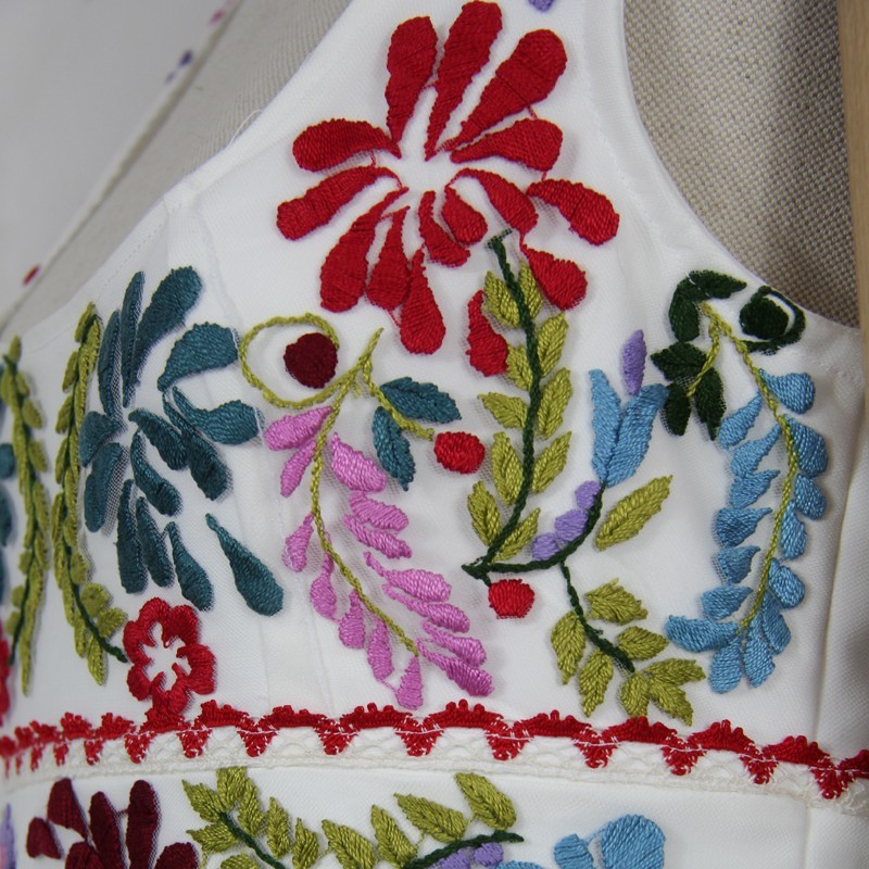 One-of-a-kind midi wedding dress on mannequin with floral details