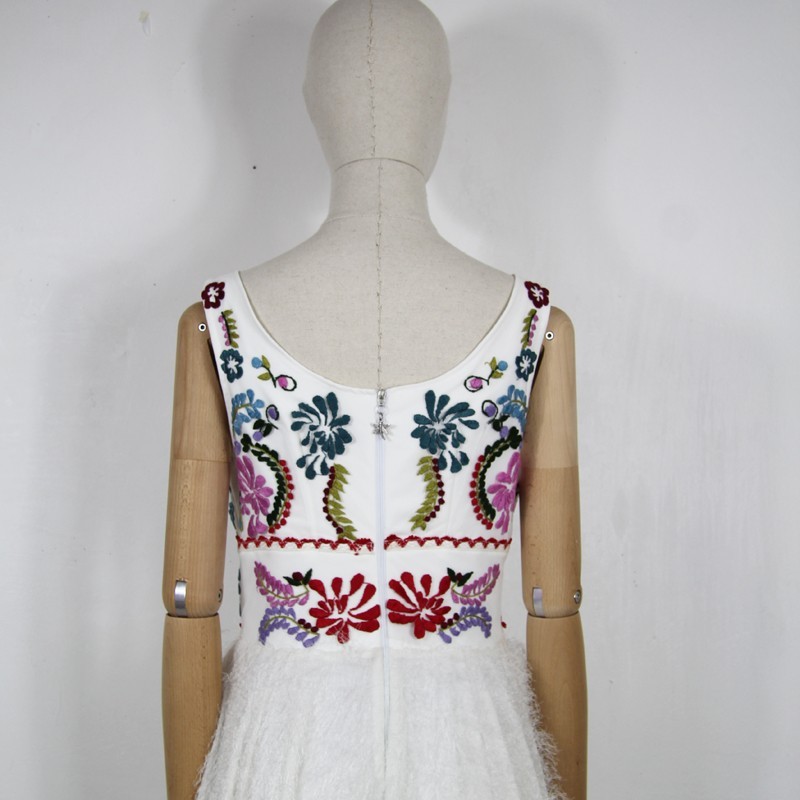 Back view of hand embroidered dress on dress form