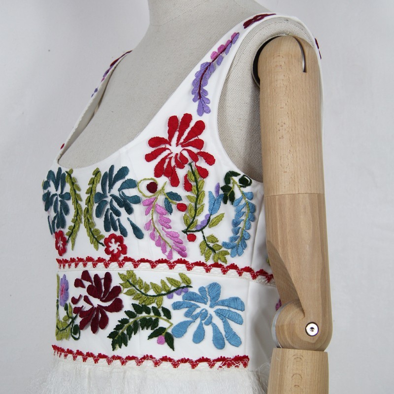 Embroidered French bridal gown displayed on mannequin