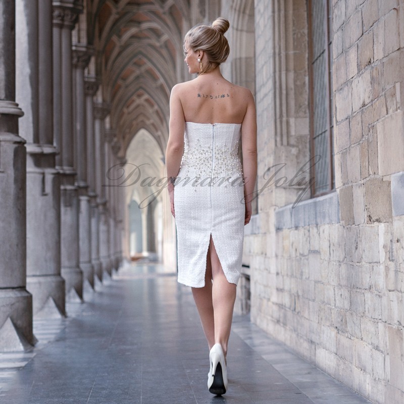 Back view of strapless pencil wedding dress showing fitted silhouette and elegant pearl detailing.