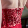 Zoom at the couture embellishments on the back of the red velvet evening dress