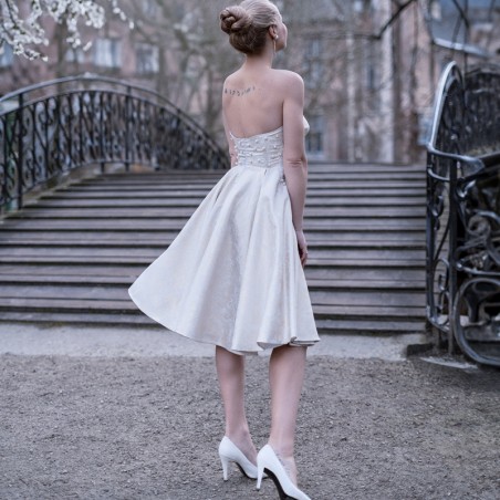 Back of unique strapless swing wedding dress with elegant detailing and French craftsmanship