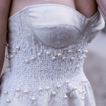 Close-up of hand embellishments on French-made strapless wedding dress.