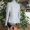 Back view of the Long asymmetrical blazer with a fluid peplum and shawl collar.