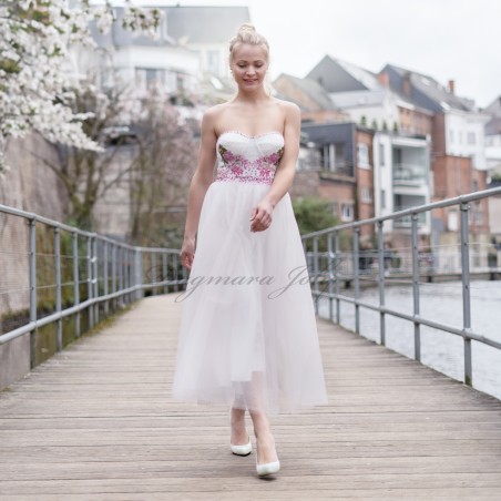 Side view of strapless midi wedding dress showing lightweight tulle skirt in motion