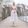 Side view of strapless midi wedding dress showing lightweight tulle skirt in motion