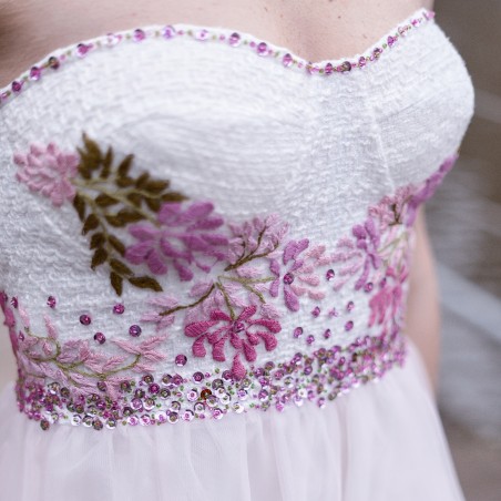 Close-up of strapless bodice with floral appliqués and soft tulle fabric