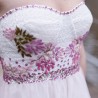 Close-up of strapless bodice with floral appliqués and soft tulle fabric