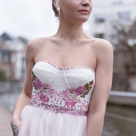 Close-up of strapless bodice with floral appliqués and soft tulle fabric