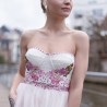 Close-up of strapless bodice with floral appliqués and soft tulle fabric
