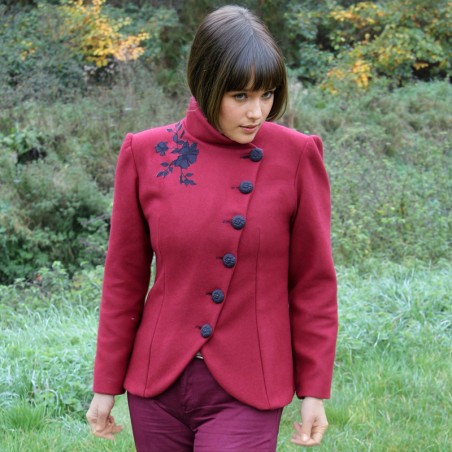 Tailor-made red wool jacket with asymmetrical closure, stylish for office or layered outerwear.