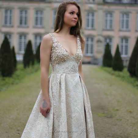 Floor-length formal gown with V-neckline and sparkling pearl decorations