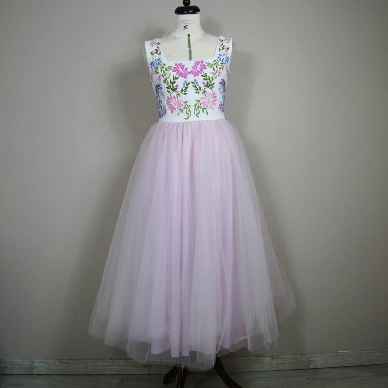 Romantic tulle and linen dress styled on mannequin with soft shadows