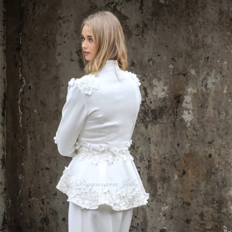Back view of a chic bride in a tailored pantsuit walking down courthouse steps.