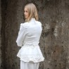 Back view of a chic bride in a tailored pantsuit walking down courthouse steps.