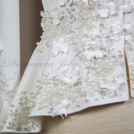 Close-up of blazer detailing with floral embroidery and pearl buttons on a luxury bridal pantsuit.