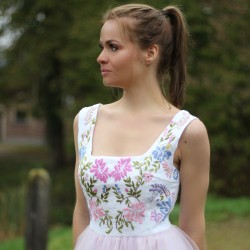 Detail of hand embroidery on  linen midi tulle dress