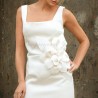 Close-up of Italian haute couture fabric with handcrafted flower embellishments on wedding dress