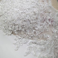 Detailed view of wedding dress train with lace and crystal appliqué