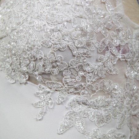 Detailed view of wedding dress train with lace and crystal appliqué