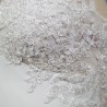 Detailed view of wedding dress train with lace and crystal appliqué