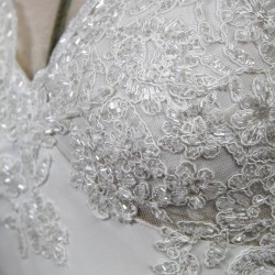 Detailed view of lace and crystal embellishments on bodice