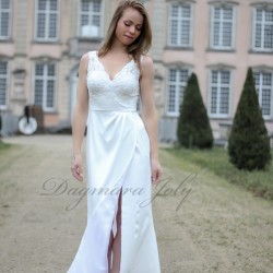 Side profile of sleeveless bridal gown with thigh-high slit and train