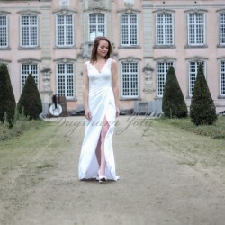 Bride walking in high slit wedding gown, front angle in motion