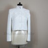 Front view of short white tweed jacket with lace and embellishments