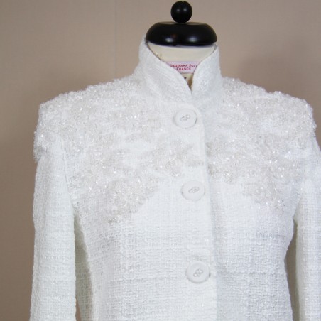 Close-up of lace details on white tweed jacket