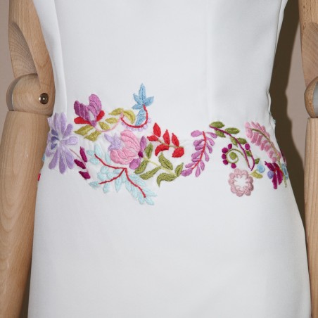 Close-up of hand-embroidered dahlias on crepe wedding dress