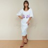Model standing in profile, showcasing the sleek fit of the midi bridal gown