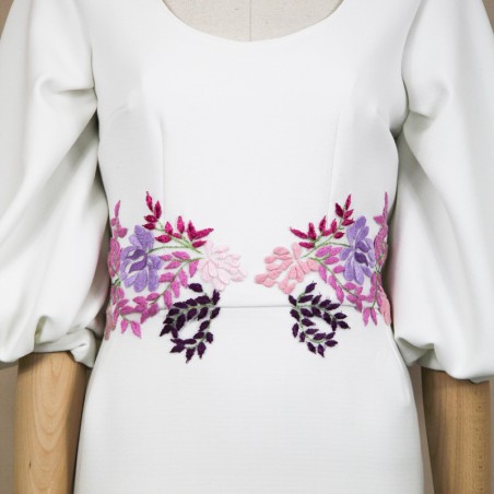 Zoomed view of the dress displayed on a mannequin in studio light