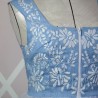 Close-up of hand-embroidered floral pattern on lin