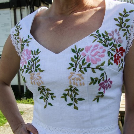 Close-up of a romantic heart-shaped neckline on an embroidered linen wedding dress.