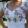Close-up of a romantic heart-shaped neckline on an embroidered linen wedding dress.