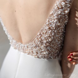 Close-up of pearl detailing and on the back showcasing artisanal texture and couture-level craftsmanship.