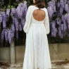 Zoomed-in detail of the open back design with lace and pearl hand embellishments.