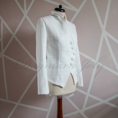 Side view of women's white bridal asymmetrical tweed jacket highlighting sleek silhouette.