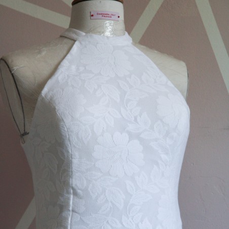 Zoomed-in view of fine French lace fabric used in custom wedding dress.