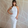 Model wearing floor-length sheath wedding dress with halter neckline, front view.