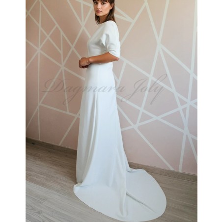 Back view of a floor-length wedding gown with dolman sleeves and a dramatic cathedral train extending gracefully behind