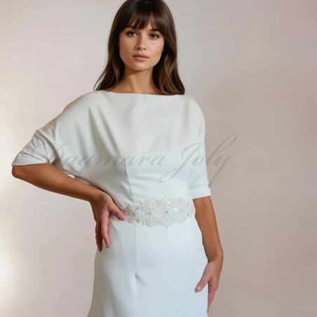 Close-up of the front bodice showing fine lace embroidery, subtle beading, and the soft draping of the dolman sleeves