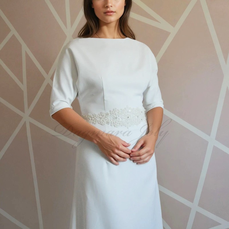 Front view of a floor-length wedding dress with dolman sleeves