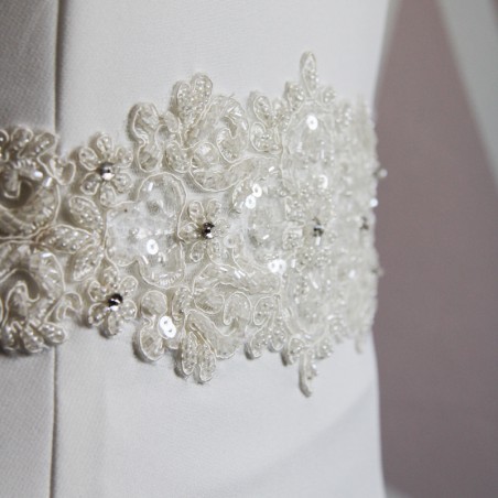 Close-up of the front bodice showing fine lace embroidery,