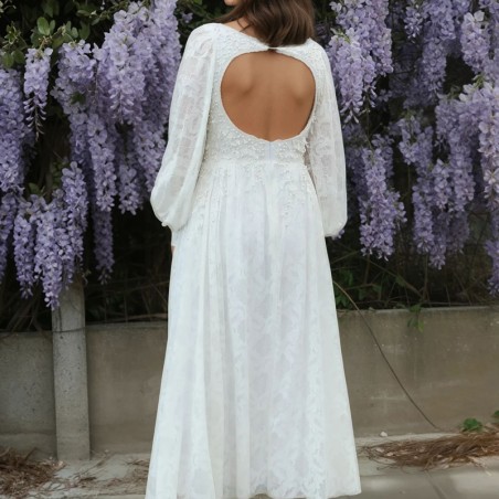 Zoomed-in detail of the open back design with lace and pearl hand embellishments.