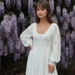 Close-up of the dress’s neckline showing delicate lace and pearl embellishments on lace fabric