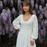 Close-up of the dress’s neckline showing delicate lace and pearl embellishments on lace fabric