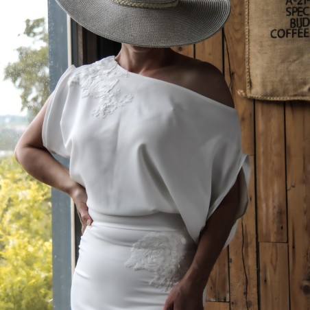 Close-up of crepe fabric and off-the-shoulder neckline detail