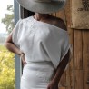 Close-up of crepe fabric and off-the-shoulder neckline detail